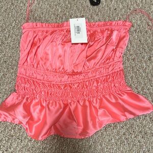 Boutique Pretty pink silk like strapless tube top.